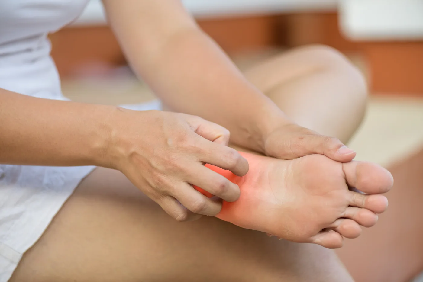 Close-up of a foot with nerve pain radiating in the sole, a common sign of peripheral neuropathy